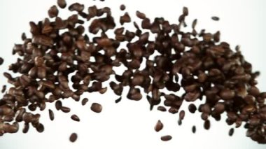 Kahve çekirdekleri çarpışmasının süper yavaş çekimi. Beyaz arka planda izole edilmiş. Yüksek hızlı sinema kamerası, 1000 fps..