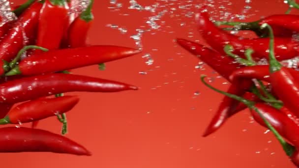 Σούπερ Αργή Κίνηση Χρωματιστές Πιπεριές Τσίλι Σύγκρουση Κόκκινο Φόντο Κινηματογραφήθηκε — Αρχείο Βίντεο
