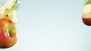 Elmaların su sıçratarak havaya vurması süper yavaş bir hareket. Yüksek hızlı sinema kamerası, 1000 fps..