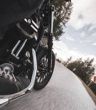 Dağın asfalt yolunda motosiklet sürüyorum. Ön tekerleğin ayrıntıları, yakın plan.,