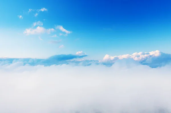 Beautiful sunset cloudy sky from aerial view. Airplane view above clouds