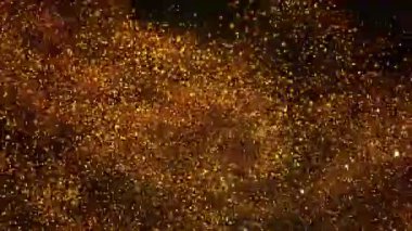 Siyah zemin üzerinde ışıldayan altın parçacıkların süper yavaş çekimi. Sığ odak derinliği. Yüksek hızlı sinema kamerası, 1000 fps..