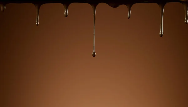 Dripping melted chocolate on soft background, abstract background