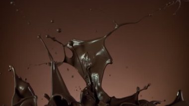 Koyu sıcak çikolatanın çok yavaş sıçratması. Sinema, yüksek hızlı kamera, 1000fps.