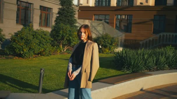 Portrét krásné módní Smíšené rasy bokovky žena nosí svetr a džíny. Ona má výhled na město ve veřejném parku — Stock video