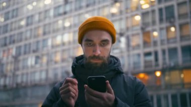 Tarama Internet City de akşam sokak Smartphone yakışıklı genç adam