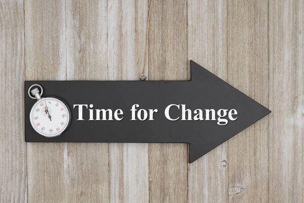 Time for change text on an arrow chalkboard sign with a stopwatch on weathered wood