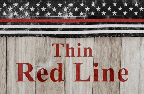 Thin Red Line text with USA patriotic old thin red line flag on a weathered wood