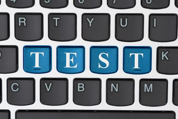 Taking a test on line, A close-up of a keyboard with blue highlighted text Test