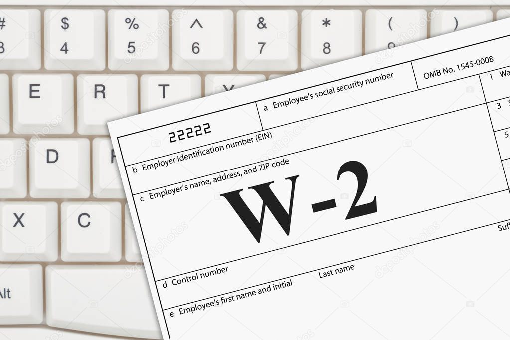 A US Federal tax W2 income tax form on a keyboard