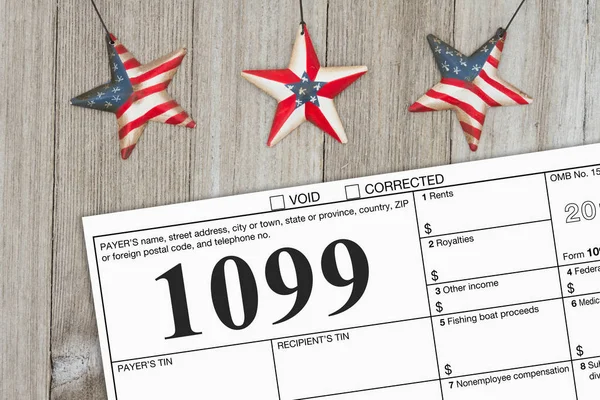 A US Federal tax 1099 income tax form on weathered wood with USA stars