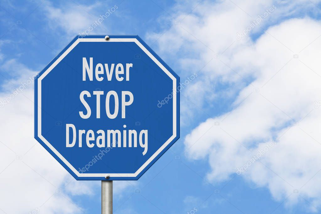 Blue and white Never Stop Dreaming stop sign with sky background
