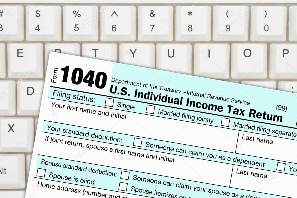 A US Federal tax 1040 income tax form on a keyboard