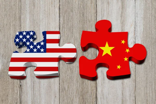 Relationship between the USA and China, Two puzzle pieces with the flags of USA and China on weathered wood