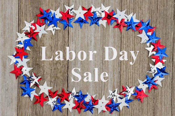 Labor Day Sale text with red, white and blue stars on weather wood