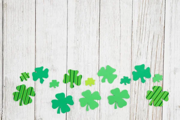 Green shamrocks on weathered whitewash textured wood background — Stock Photo, Image