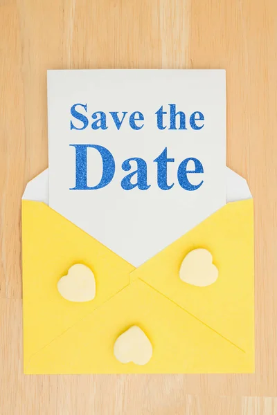 Save the Date message on white card and hearts with a yellow env — Stock Photo, Image