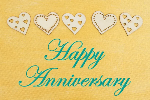 Happy Anniversary greeting with wood hearts Stock Image