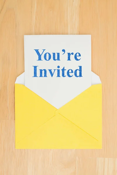 You're Invited message on white card with a yellow envelope — Stock Photo, Image