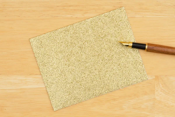 Gold glitter blank Grußkarte mit Stift auf texturiertem Holzrücken — Stockfoto