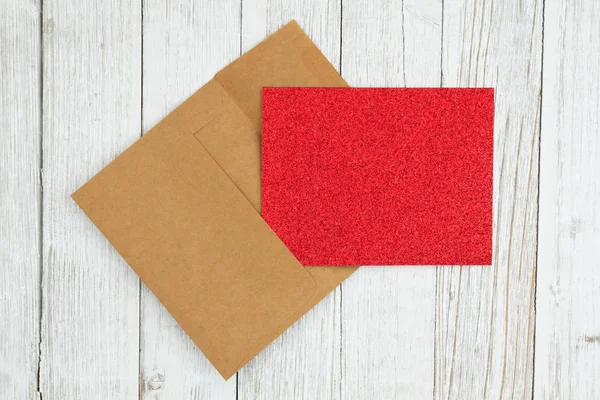 Red glitter blank greeting card and envelope on weathered whitew — Stock Photo, Image