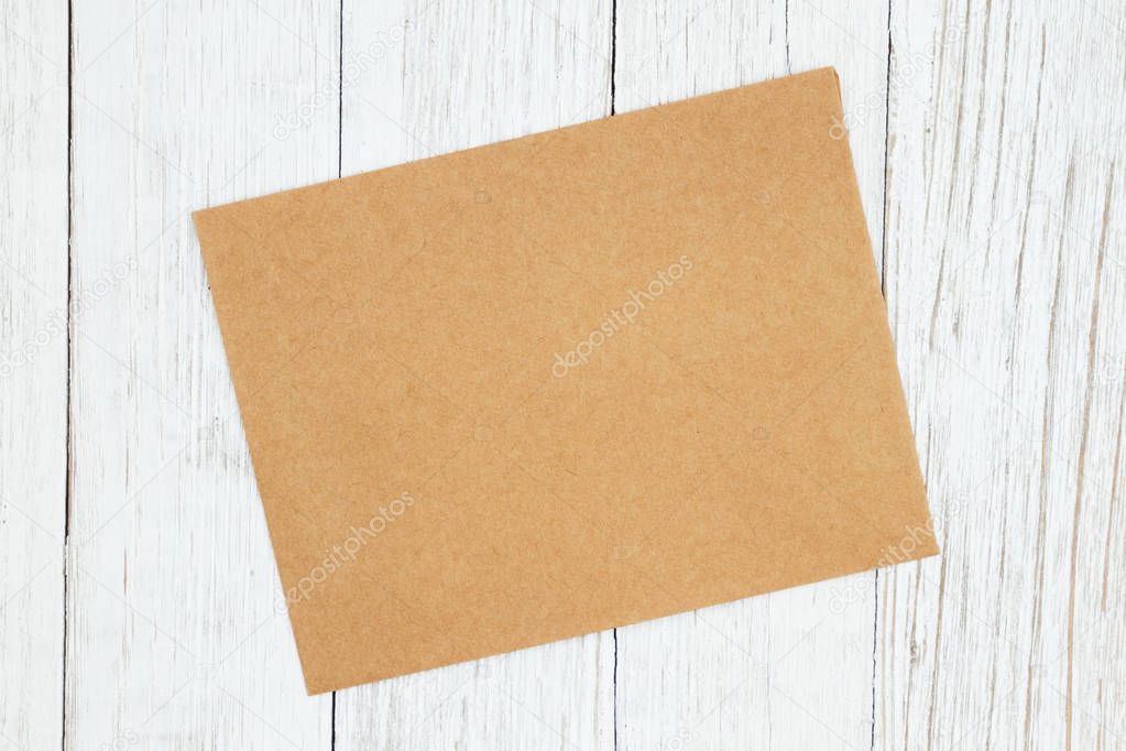 Blank greeting card on weathered whitewash textured wood backgro