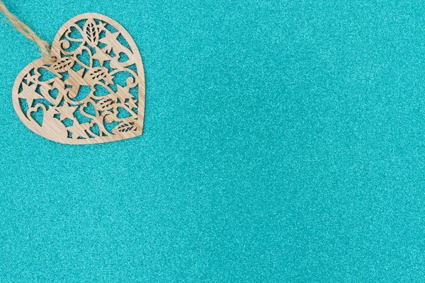 Wood heart on bright teal glitter background — Stock Photo, Image