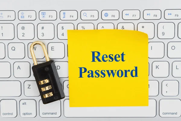 Reset password with lock on a keyboard with a sticky note — Stock Photo, Image