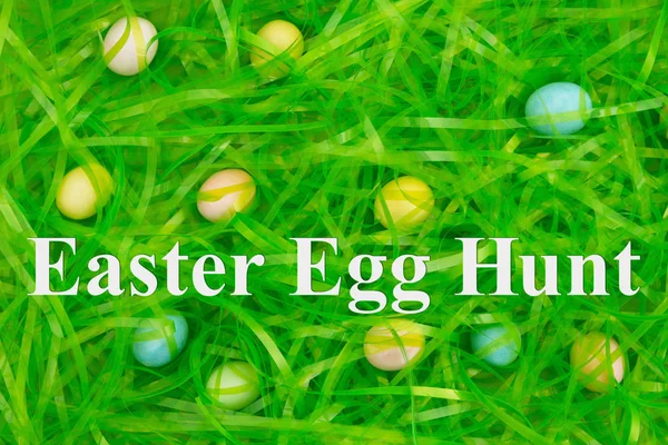 Easter egg hunt with Easter green grass with hidden eggs — Stock Photo, Image