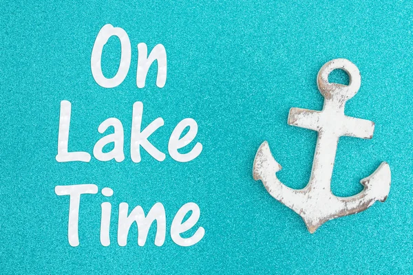 On lake time message on weathered anchor on a turquoise glitter — Stock Photo, Image