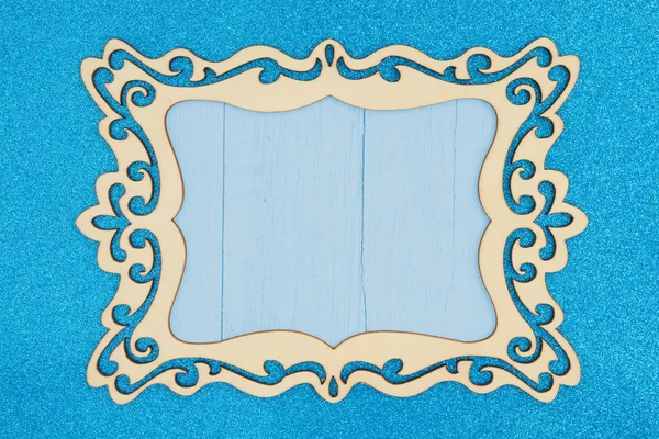 Quadro de imagem de madeira em um fundo de brilho azul — Fotografia de Stock