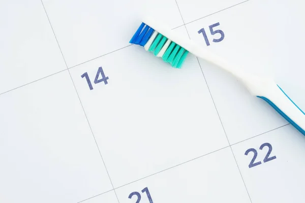 Monthly calendar with a toothbrush — Stock Photo, Image