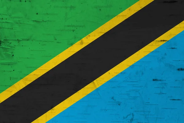A rustic old Tanzania flag on weathered wood — Stock Photo, Image