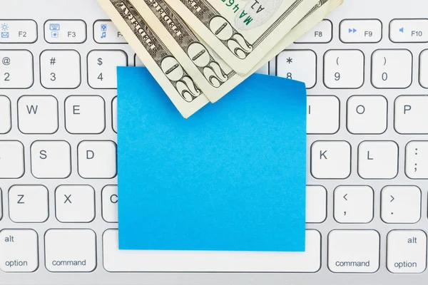 Pieniądze na klawiaturze z pustą notatkę samoprzylepna — Zdjęcie stockowe