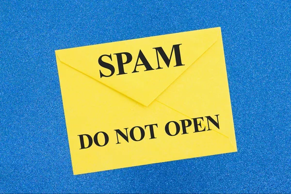 La advertencia del Spam no abre el mensaje en el sobre blanco en azul Fotos de stock