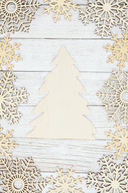 Wood Christmas tree with wood snowflakes on weathered whitewash 