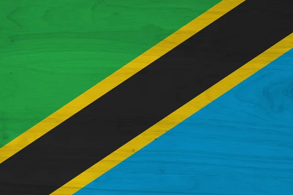 A rustic old Tanzania flag on weathered wood — Stock Photo, Image