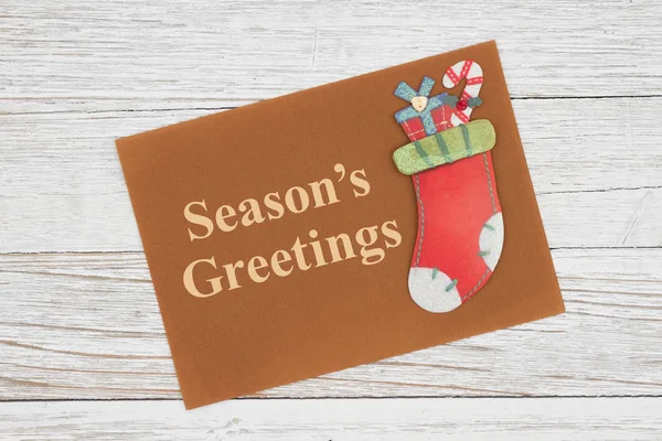 Season\'s Greetings message on greeting card with Christmas stock