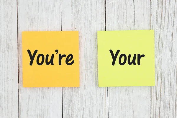 You're and your on two sticky notes on weathered whitewash textu — Stock Photo, Image