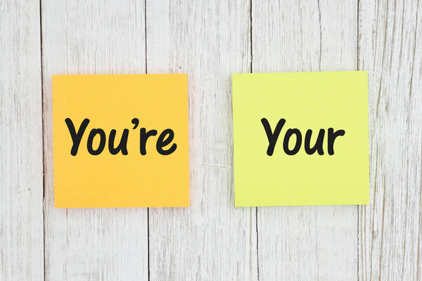 You're and your on two sticky notes on weathered whitewash textu