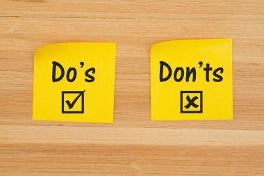 Do's and Don'ts on two sticky notes on textured wood desk clipart