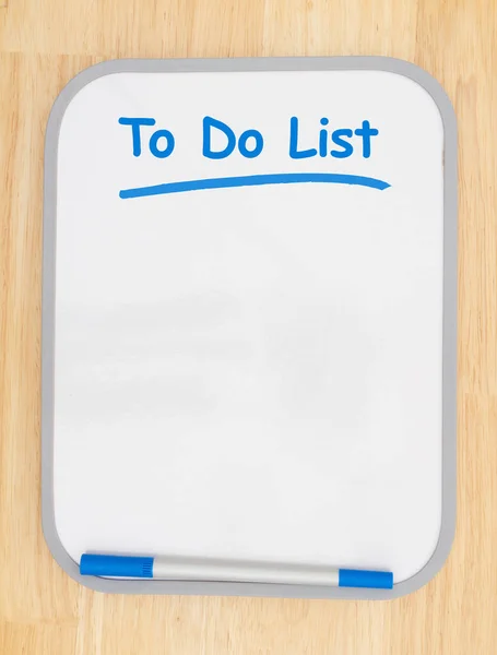Om lijst te doen op wit droog uitwisbaar bord met marker op hout textuur — Stockfoto