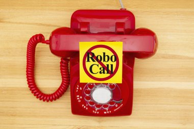 No Robo Call message on a sticky note on a red old retro rotary  clipart