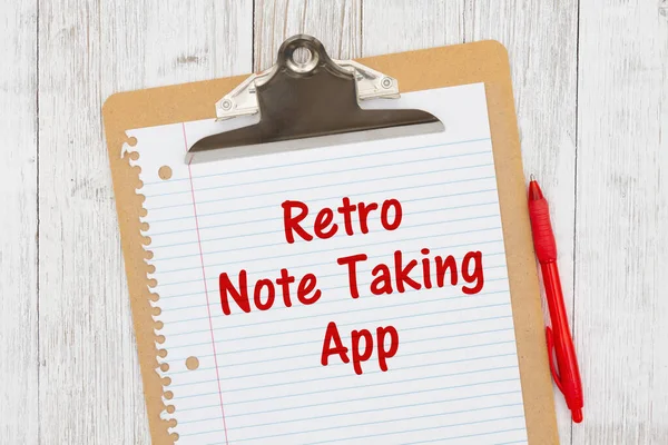 Retro Note Taking App humorous message on lined paper with a pen on a clipboard on weathered whitewash wood