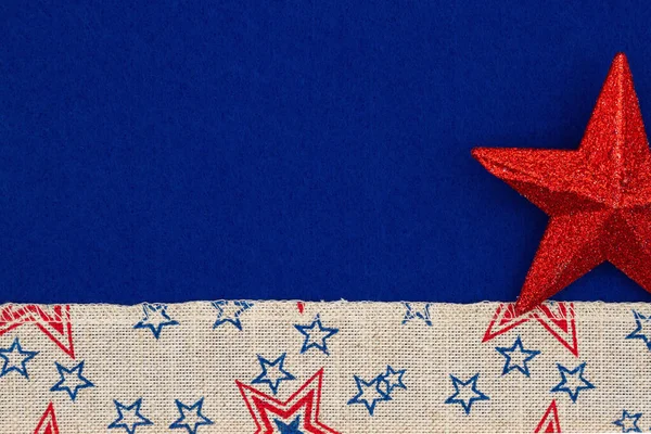 American background with retro USA stars and stripes burlap ribbon and red star on blue with copy space for your American message