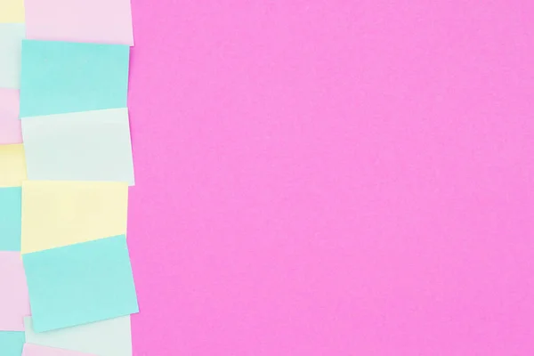 Sticky note background with multi-color notes with bright pink paper with copy space for your office or reminder message