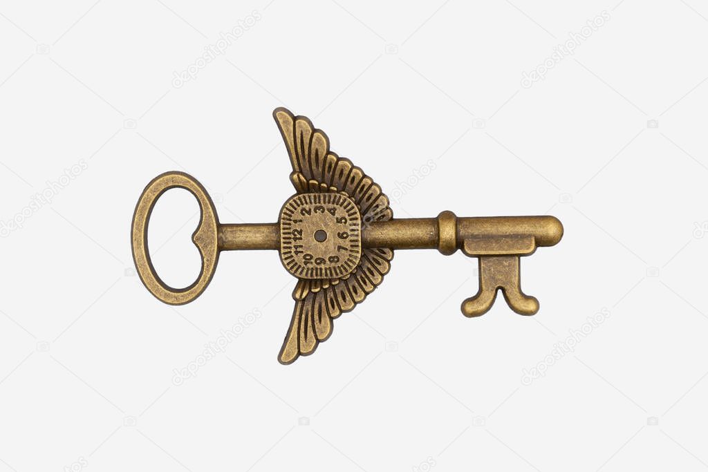 Vintage bronze time piece with wings skeleton key isolated on white