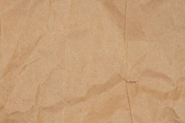 Kahverengi ambalaj kağıdı arka planında ambalaj mesajınız için kopyalama alanı olan tahıl dokusu ya da doku olarak kullanılacak