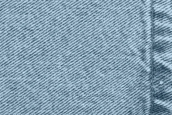 蓝色牛仔裤的斜纹棉布材料与背景与复制空间的消息或使用作为纹理 图库图片