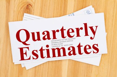 Quarterly Estimates word message on business envelope addresses to IRS on a wood desk clipart